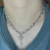 Double pearl and steel cross drop necklace