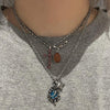 Blue swirl star necklace